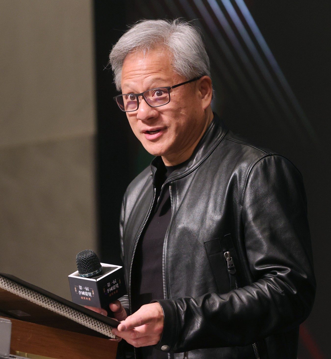 Nvidia chief executive Jensen Huang speaking at a podium.