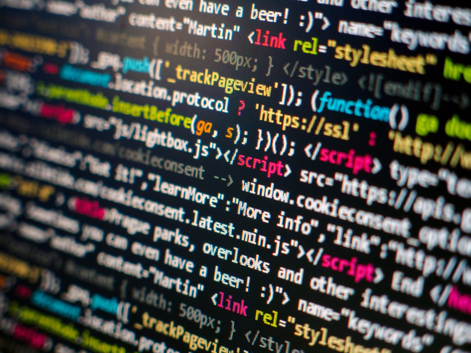 HTML and JavaScript source code highlighted on a dark computer screen.