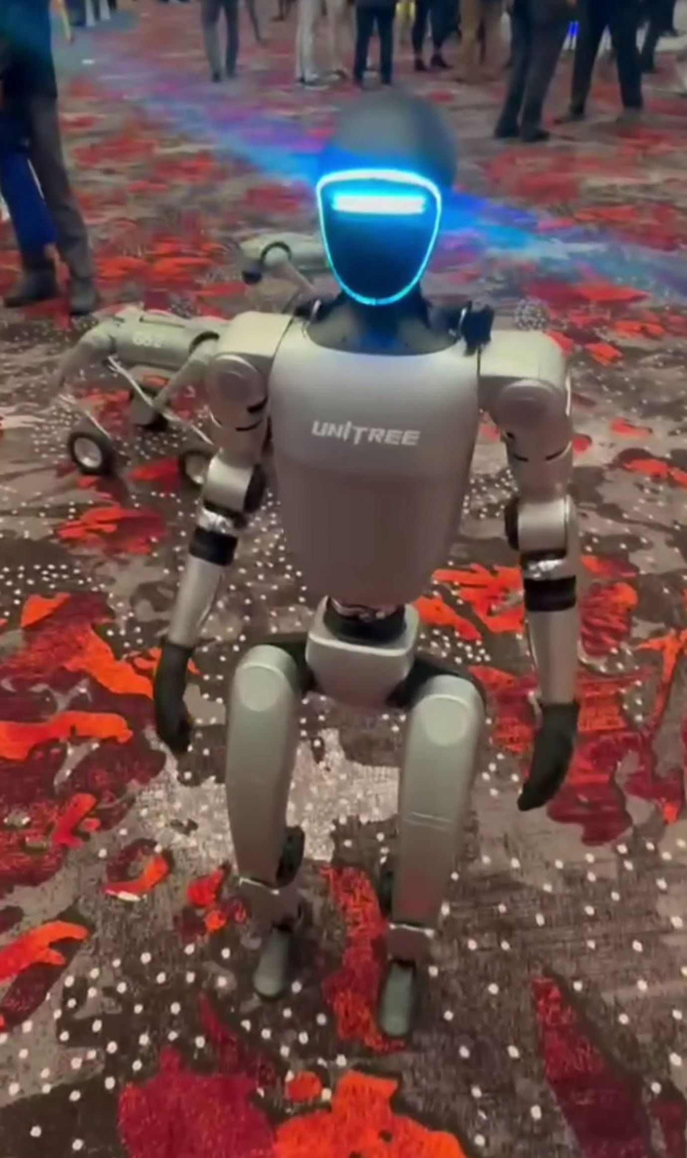 A Unitree G1 humanoid robot on display at a technology exhibition.